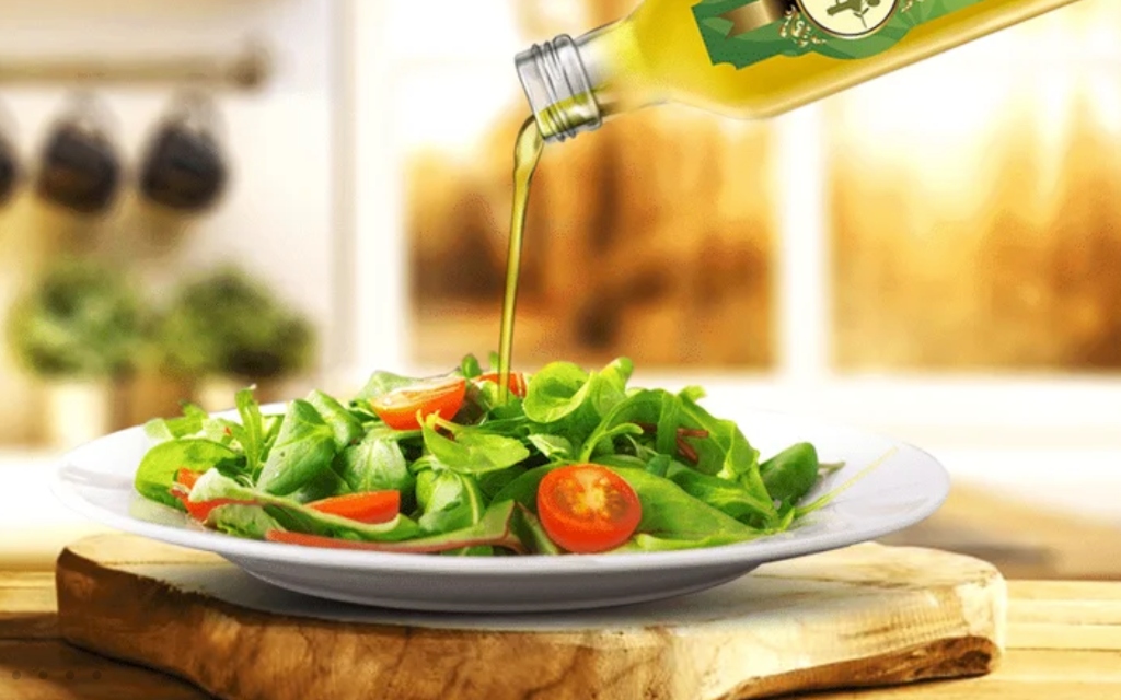 Pouring Olive Oil on Salad